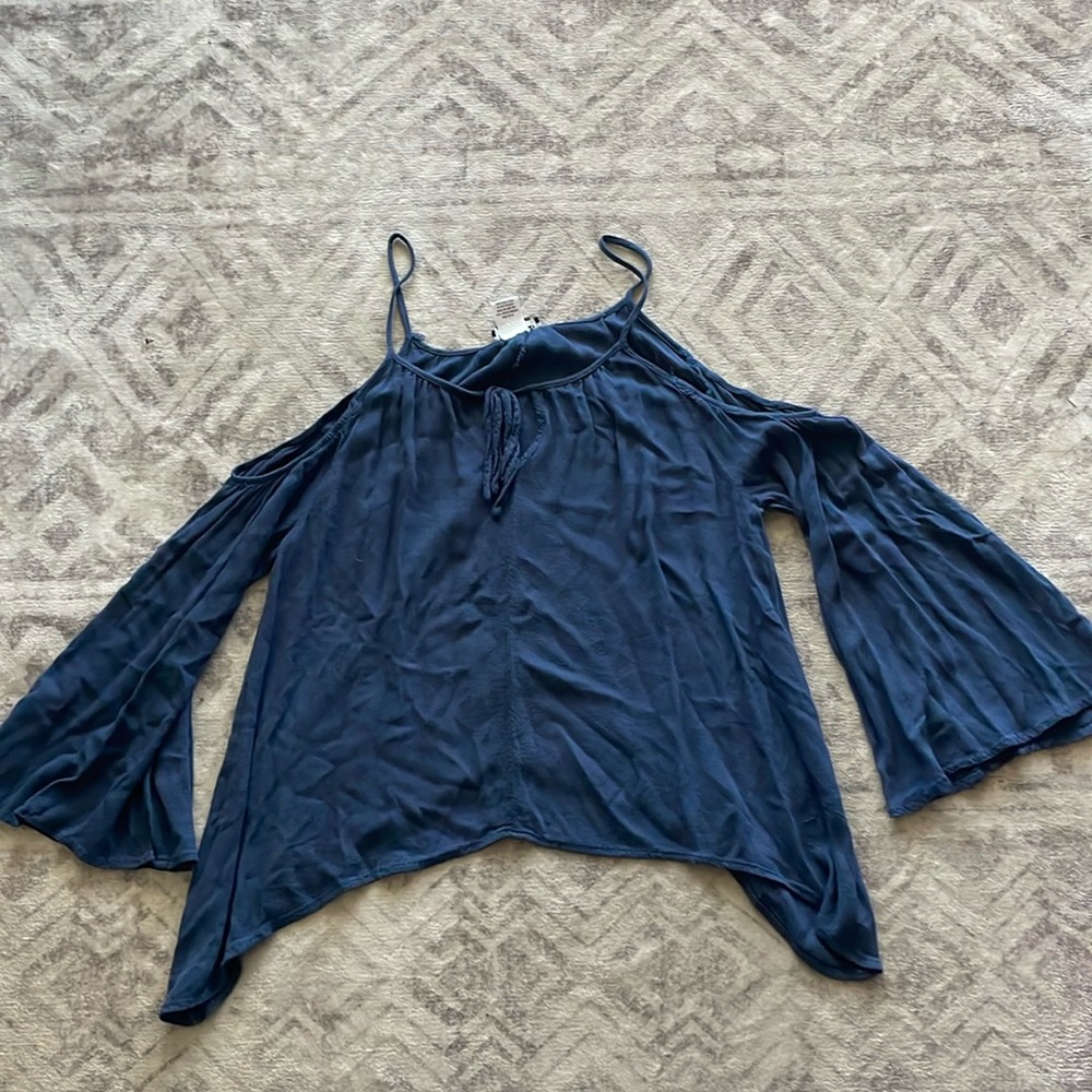 Small blue top with shoulder exposed and loose sleeves